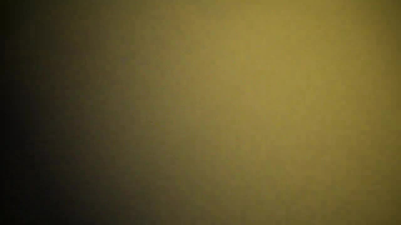 Campaign still — gold-tinted freeze frame of the crew mid-jump
