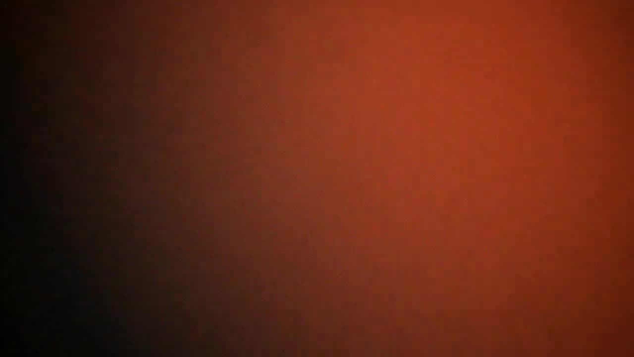 Still frame — chai splash frozen mid-air, tangerine rim light
