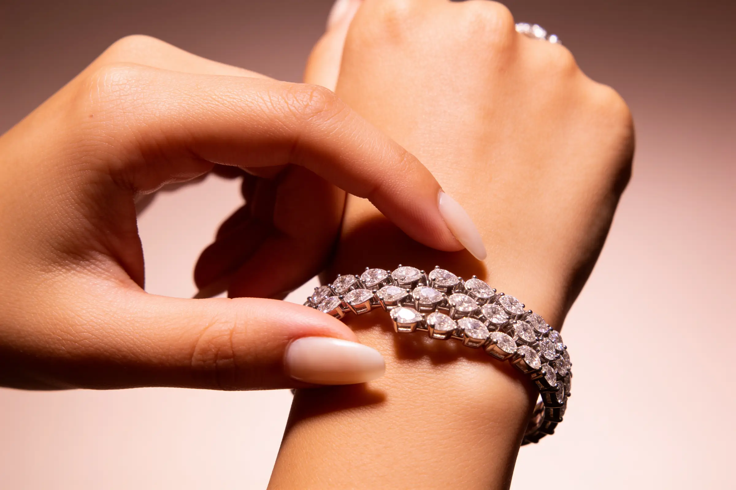 Diamos bracelet on wrist, warm skin tone against charcoal